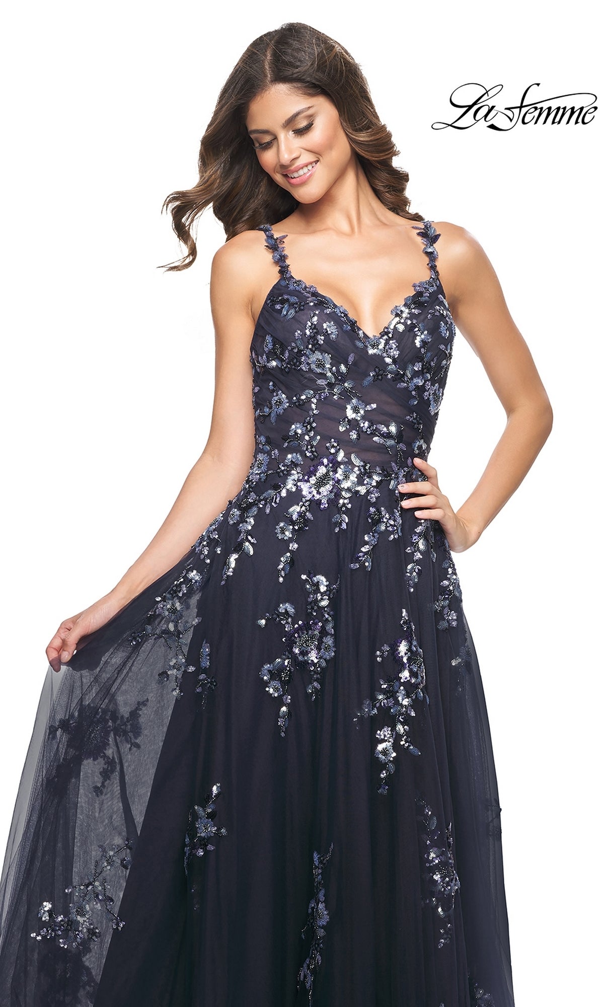 A woman poses and smiles in the La Femme Navy Long Sequin-Print Prom Dress 31936 against a white background, with the